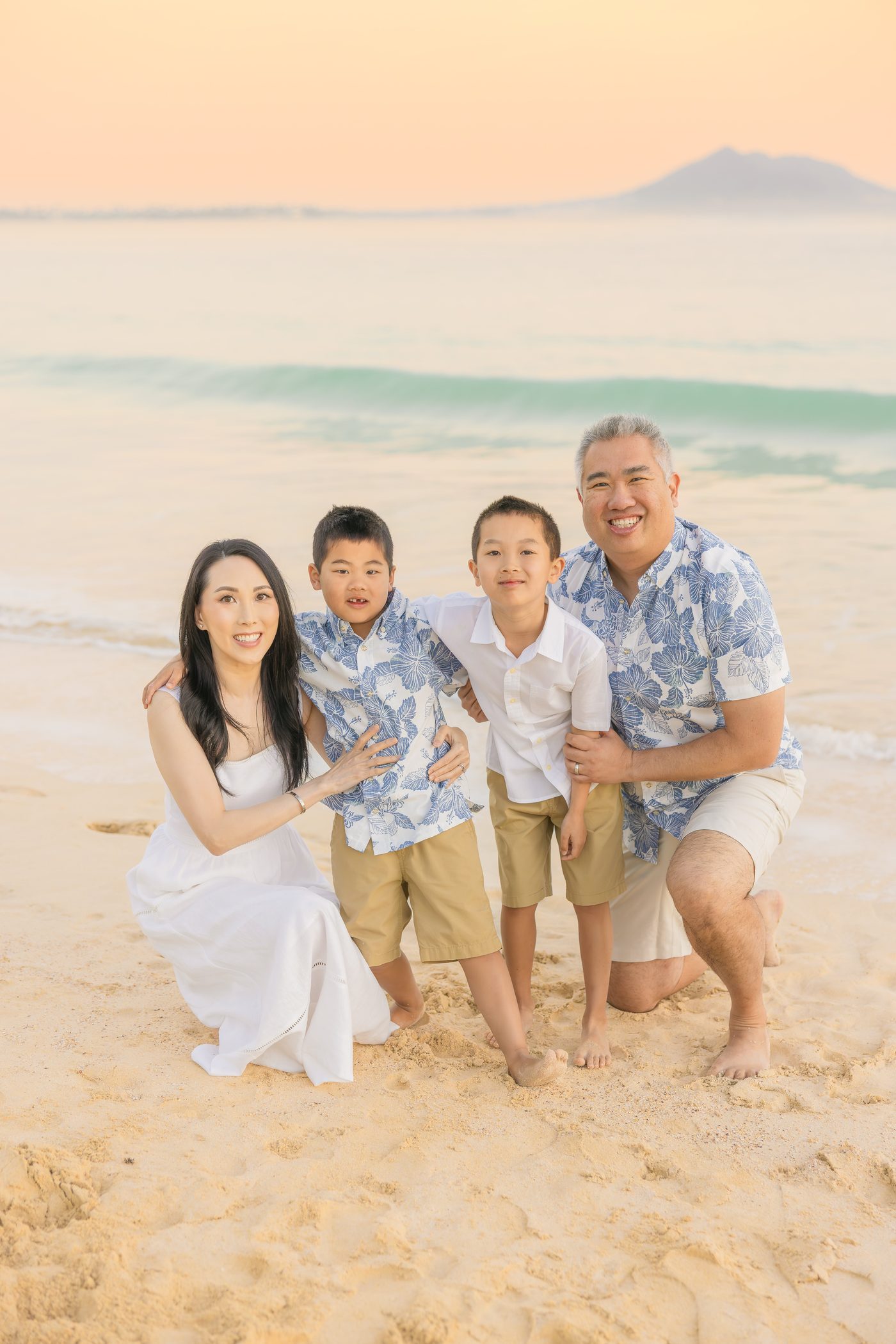 The founders' family at golden hour on a Hawai'i beach.